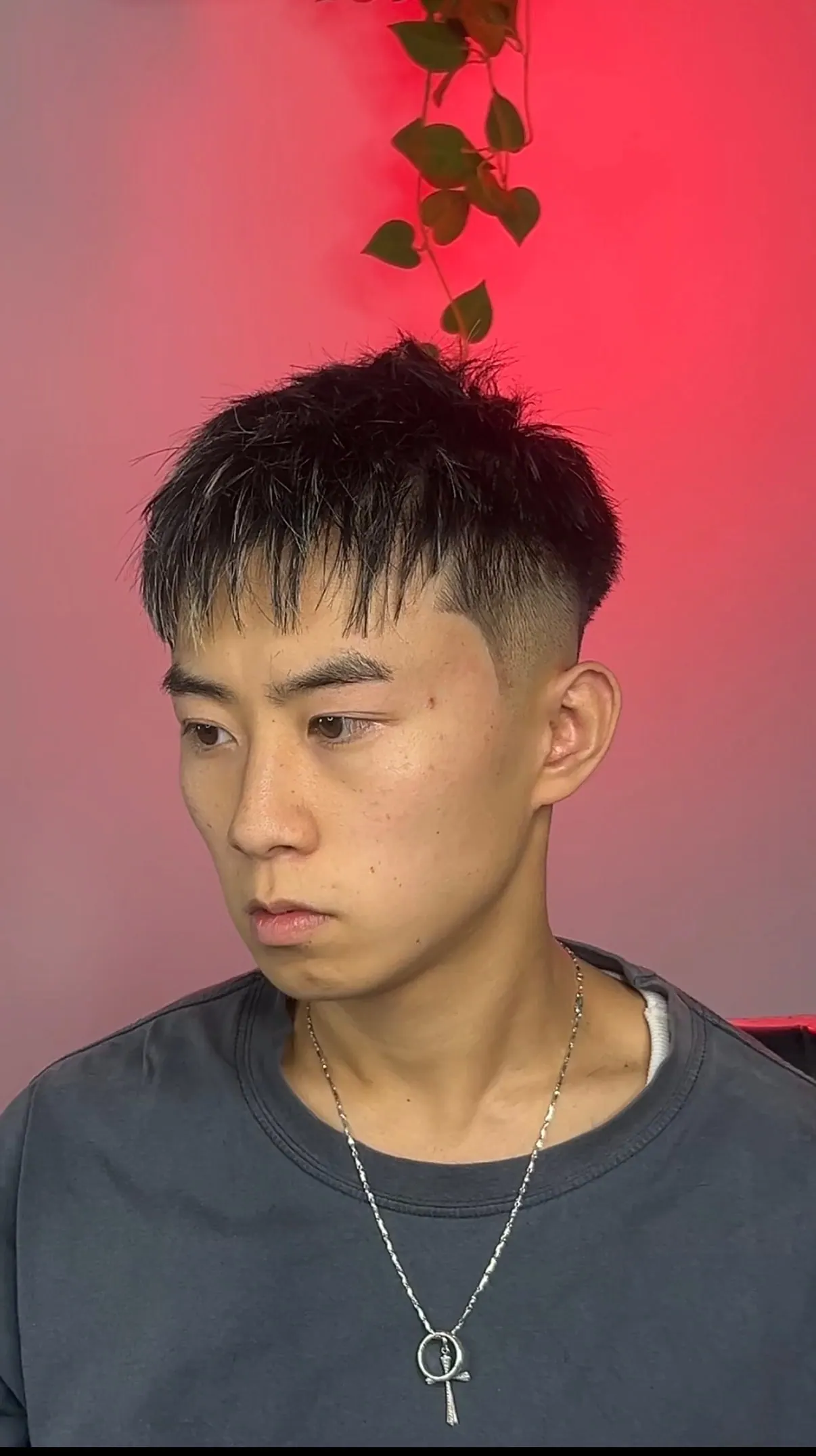Spiky top with a blunt fringe cut straight across, over a mid fade.