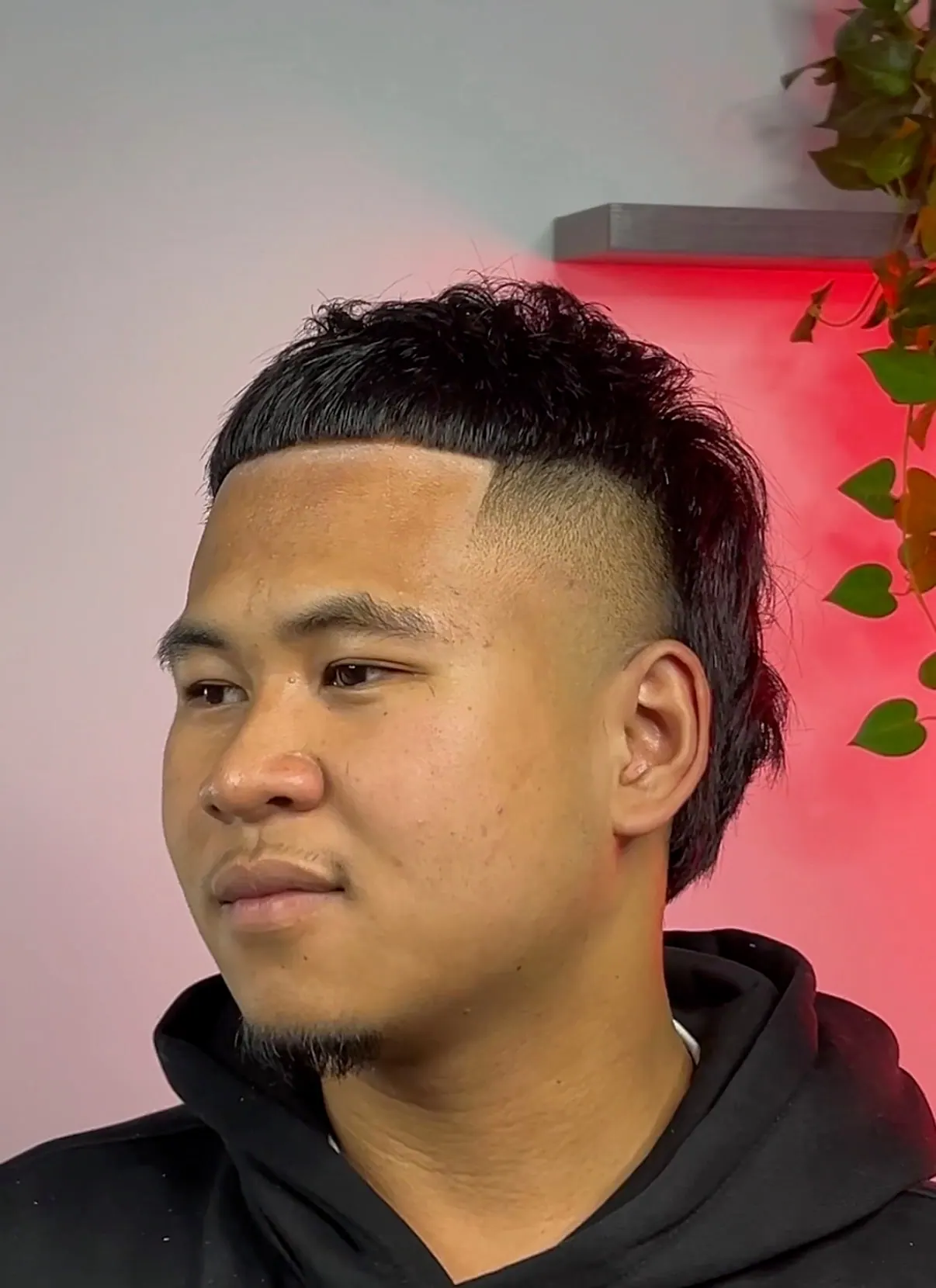 Sharp edge-up cut square across the forehead, over a burst fade with textured mullet length left through the back.